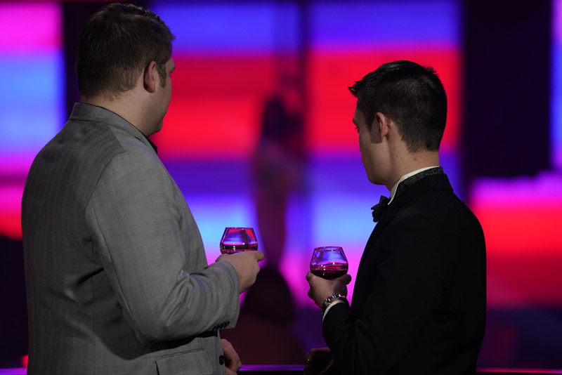 Two Guys enjoying wine and stage show at downtown Cabaret